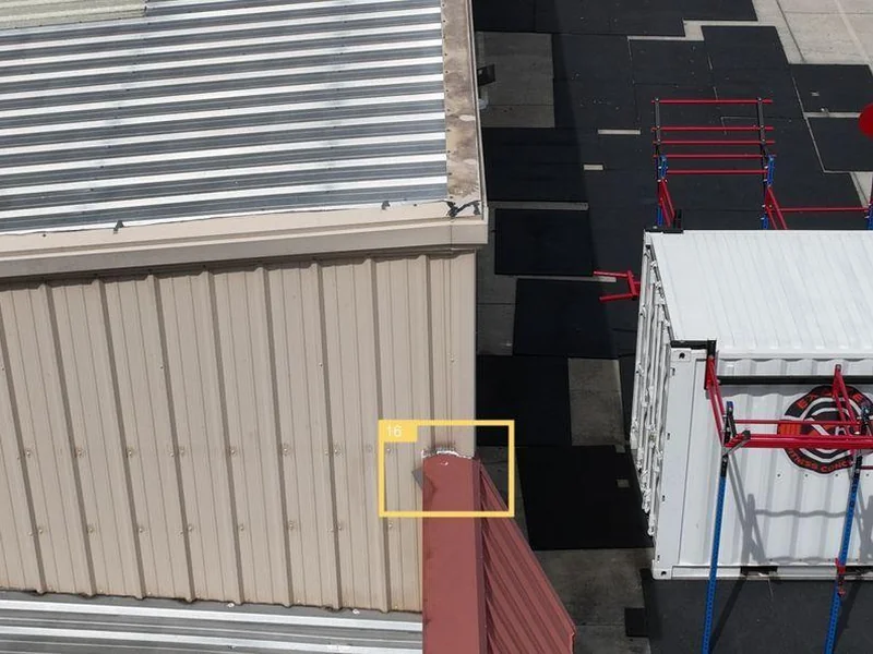 Aerial photo of the CrossFit eXalted roof edge and parapet flashing showing oxidation and weather wear