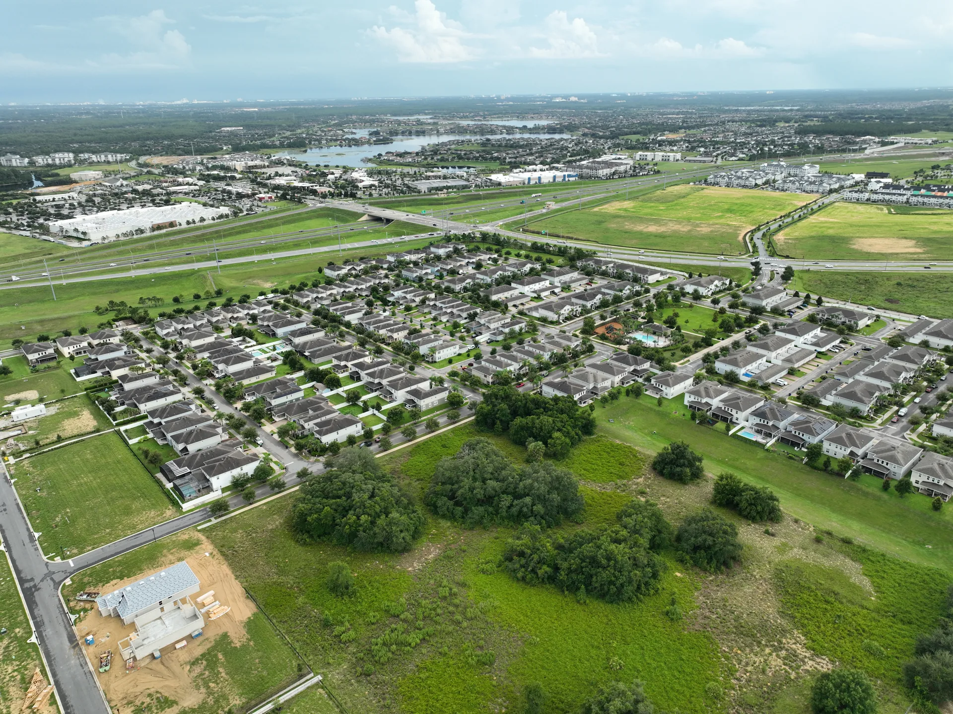 Active construction zone inside the Hamlin / Horizon West study area at the time of the photogrammetry flight, showing exposed earth, partial foundations, and equipment alongside finished residential