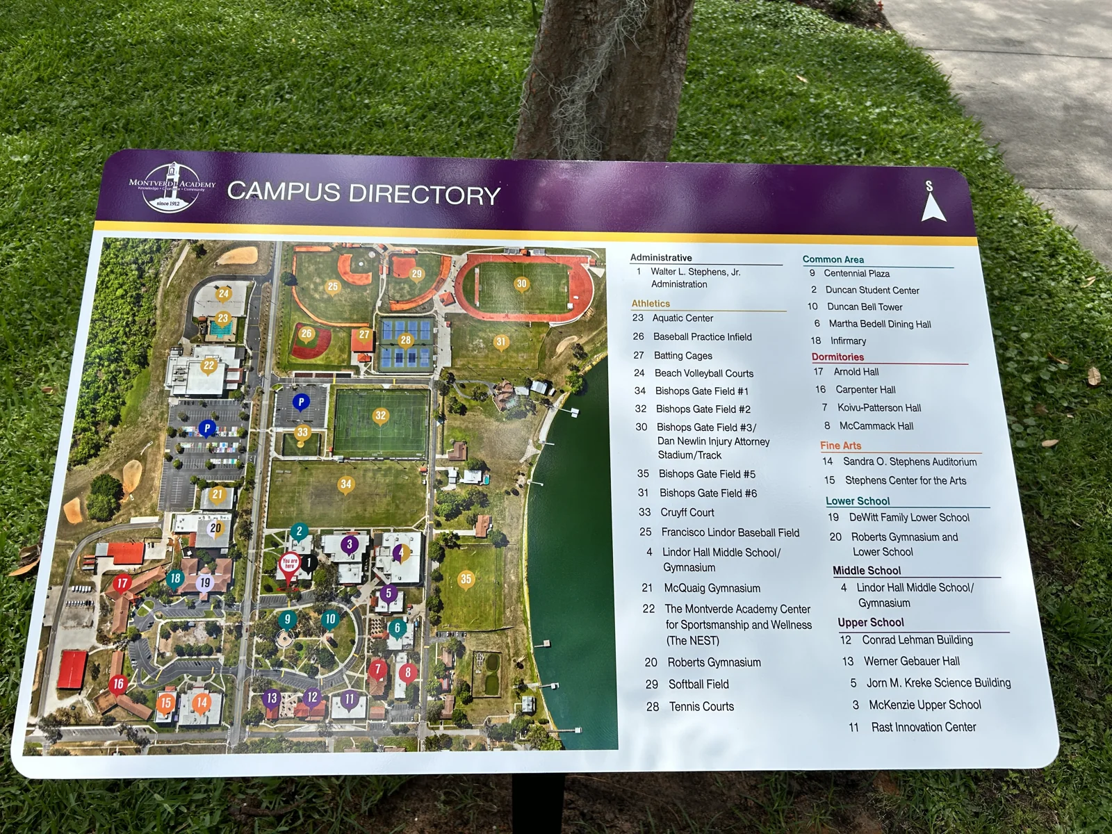 Campus directory sign at Montverde Academy showing the orthomosaic campus map with numbered buildings, color-coded areas, and a categorized legend