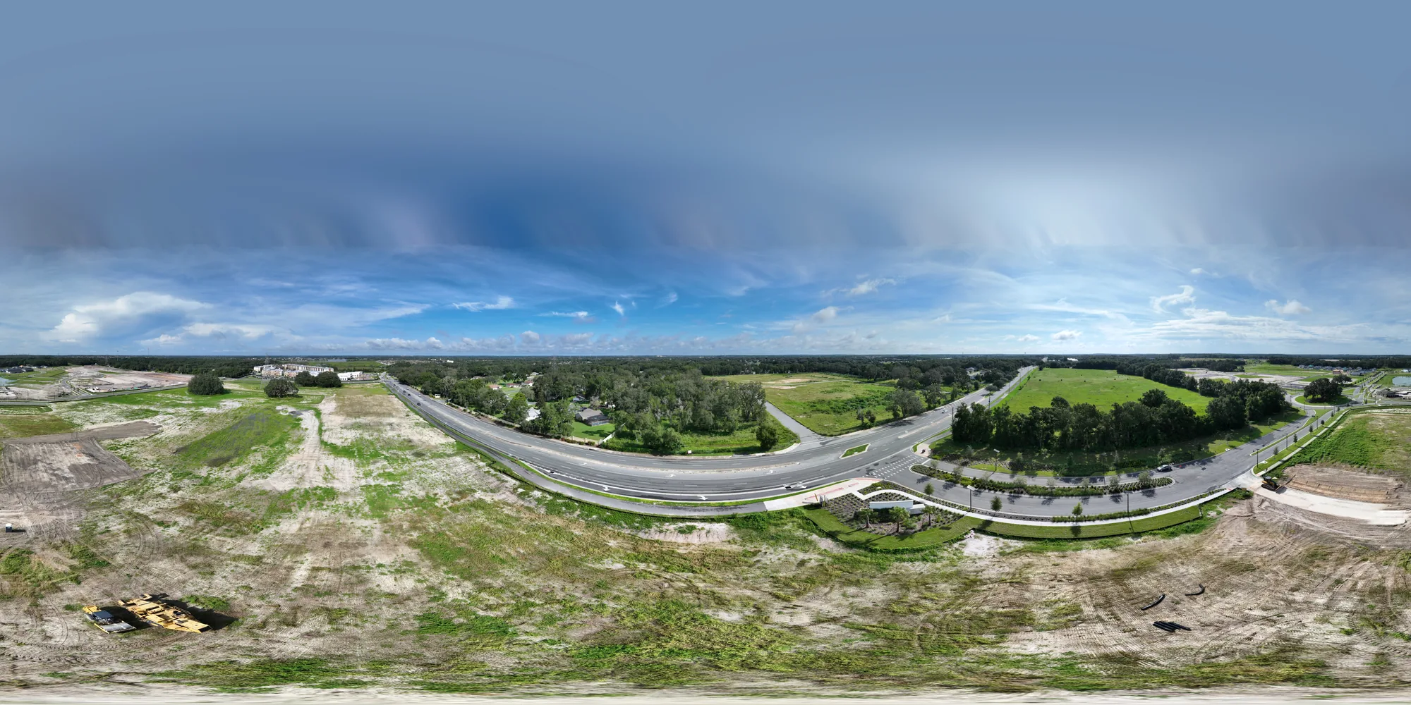 Aerial 360-degree panorama of the Walmart Supercenter construction site in Lady Lake, Florida at the start of weekly aerial documentation, showing the graded building pad and gas station pad before vertical construction began, captured August 24, 2025.
